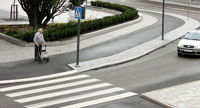 Does he want the car to drive? Or is he just about to cross the road?
